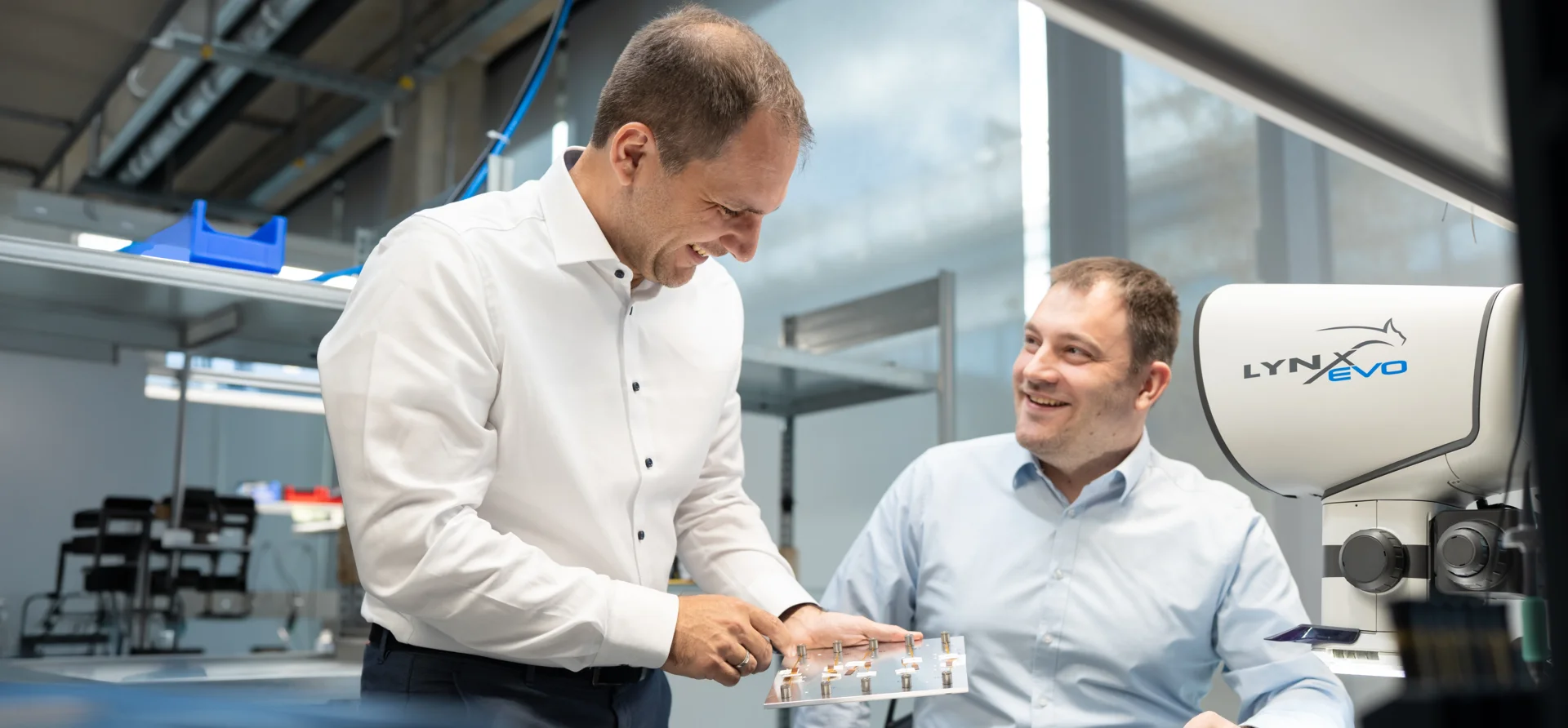 ThumbnailExperttalk Engineers inspecting miniature force torque sensor components in lab with microscope system visible