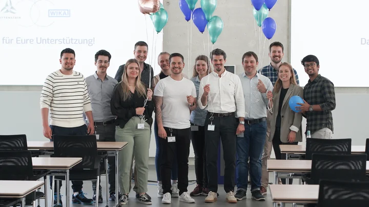 Resense team group with balloons in meeting room