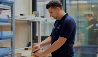 Resense engineer packaging miniature force torque sensor components at workstation
