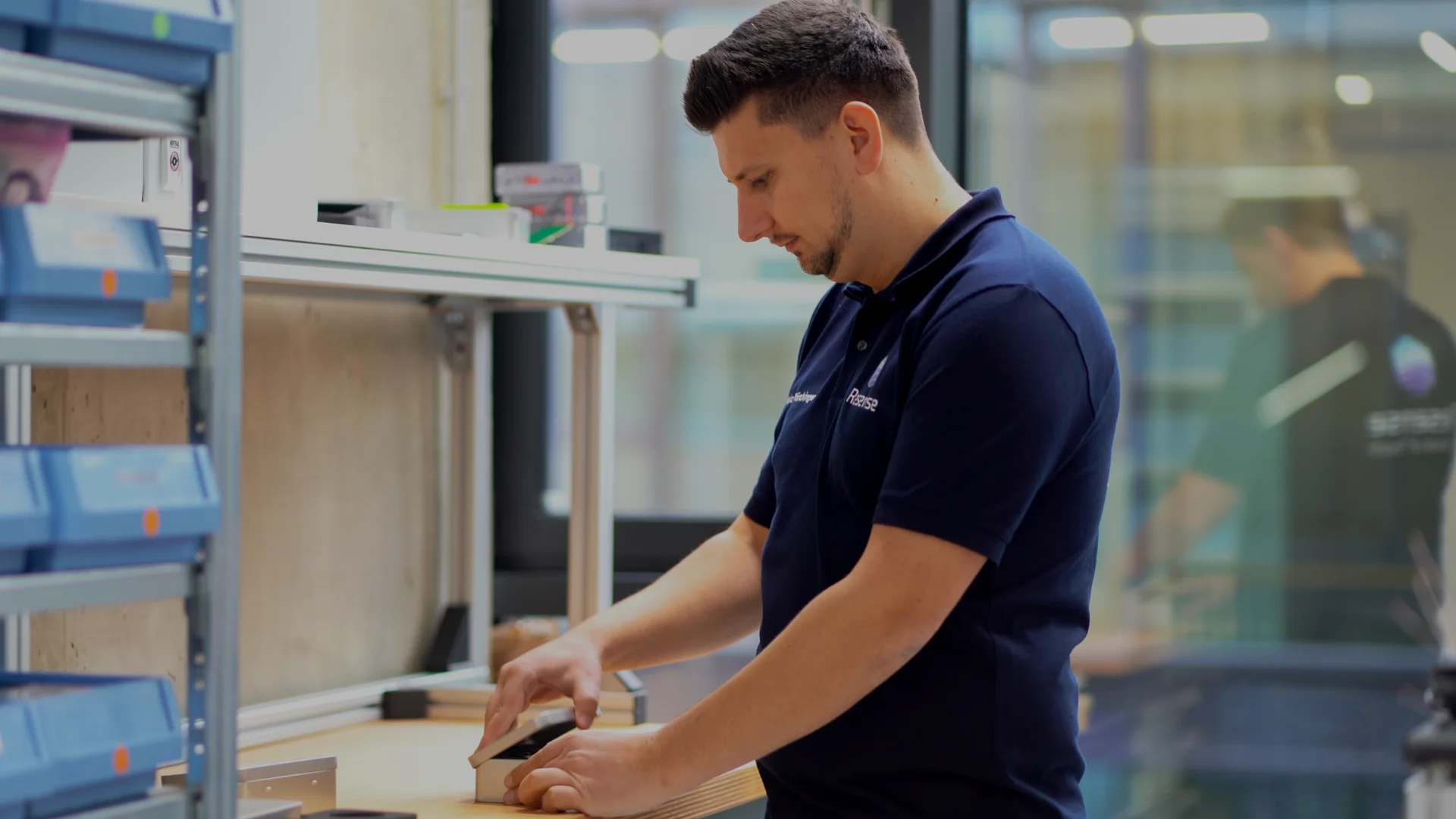 Resense engineer packaging miniature force torque sensor components at workstation