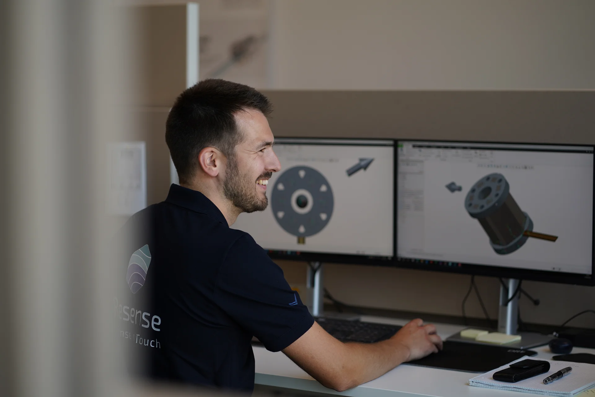 Vision Resense engineer working on CAD model of miniature force torque sensor on dual monitors